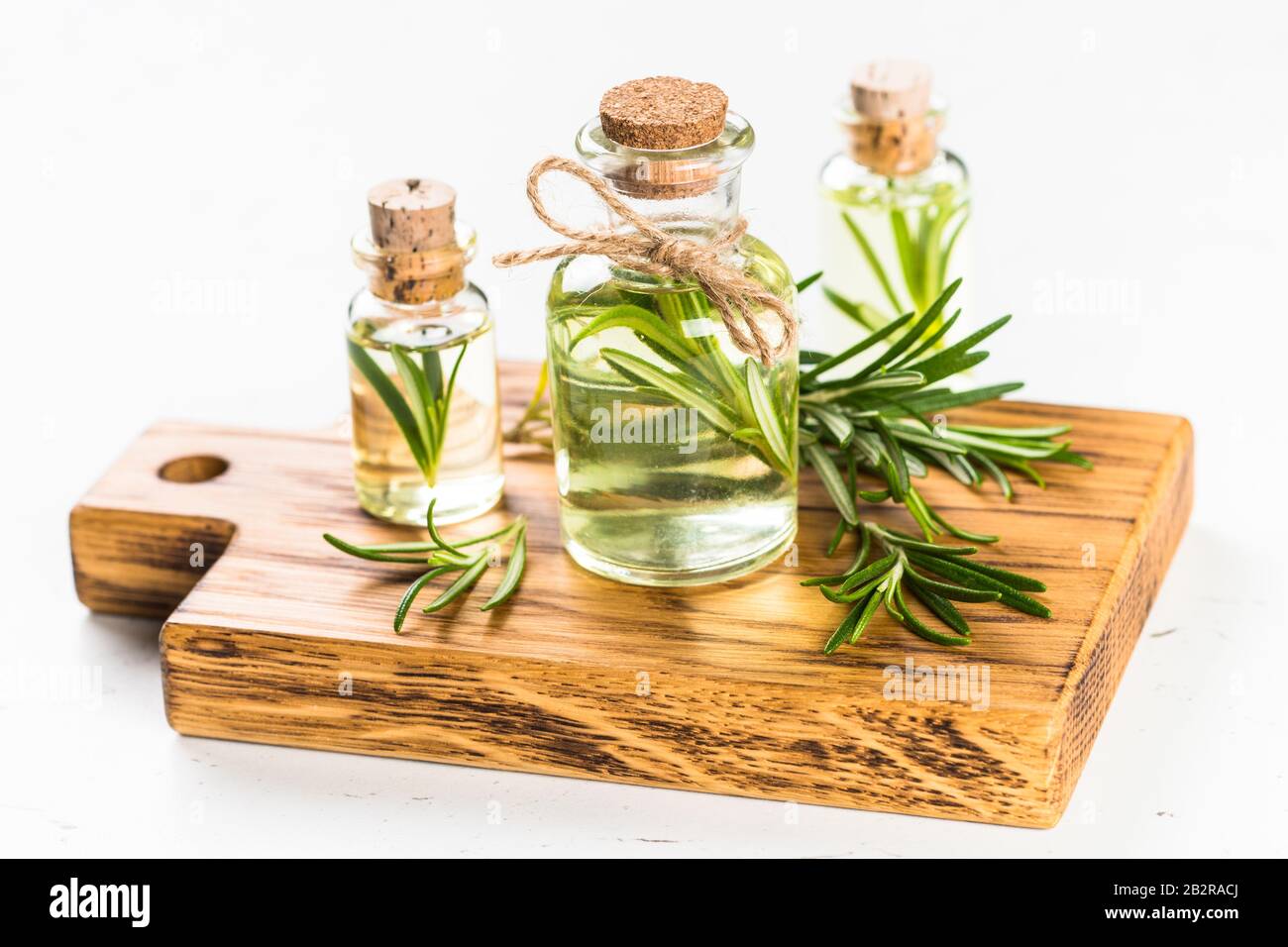 Rosemary essential oil in the bottle on white Stock Photo Alamy