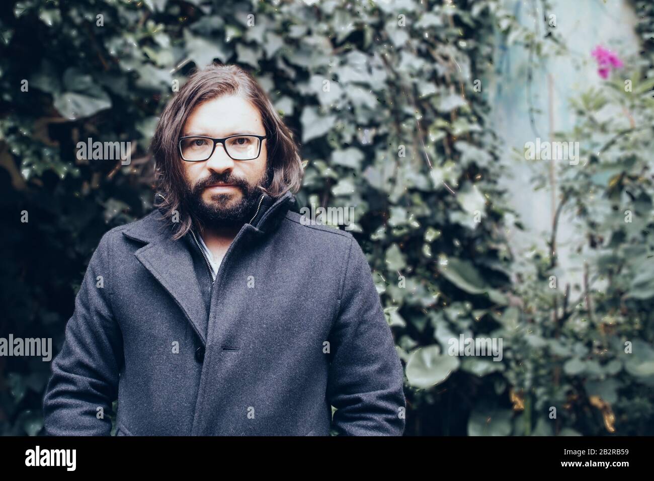 Bearded man in a black jacket looking determined Stock Photo