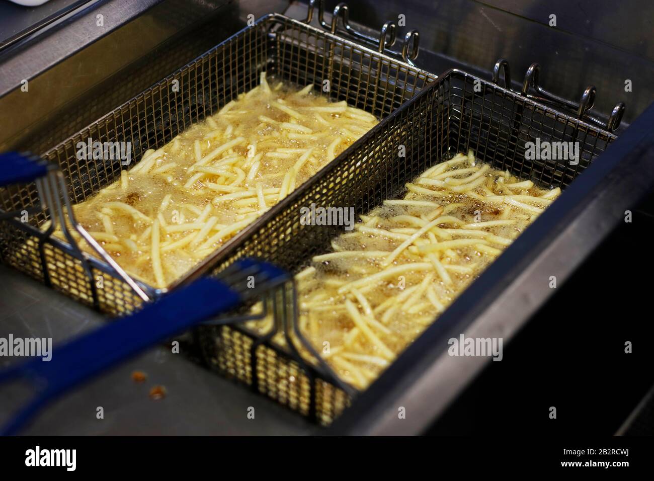 Cooking french fries. Close up of Frying french fries in the fryer in hot oil Stock Photo Alamy