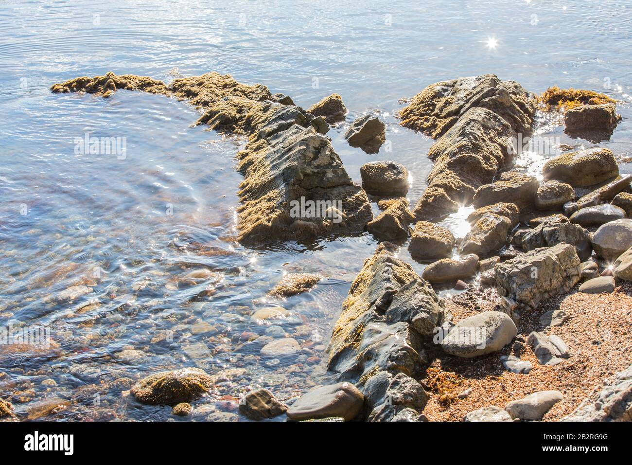 Rocky sea shore. Boulders, stones and pebbles. Closeup. Stock Photo