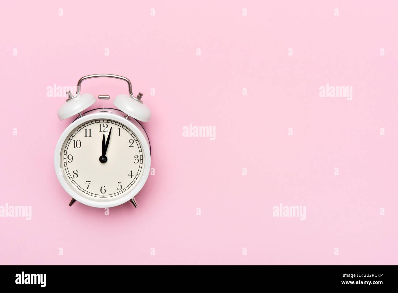 Retro alarm clock or vintage alarm clock isolated on pink background Stock Photo