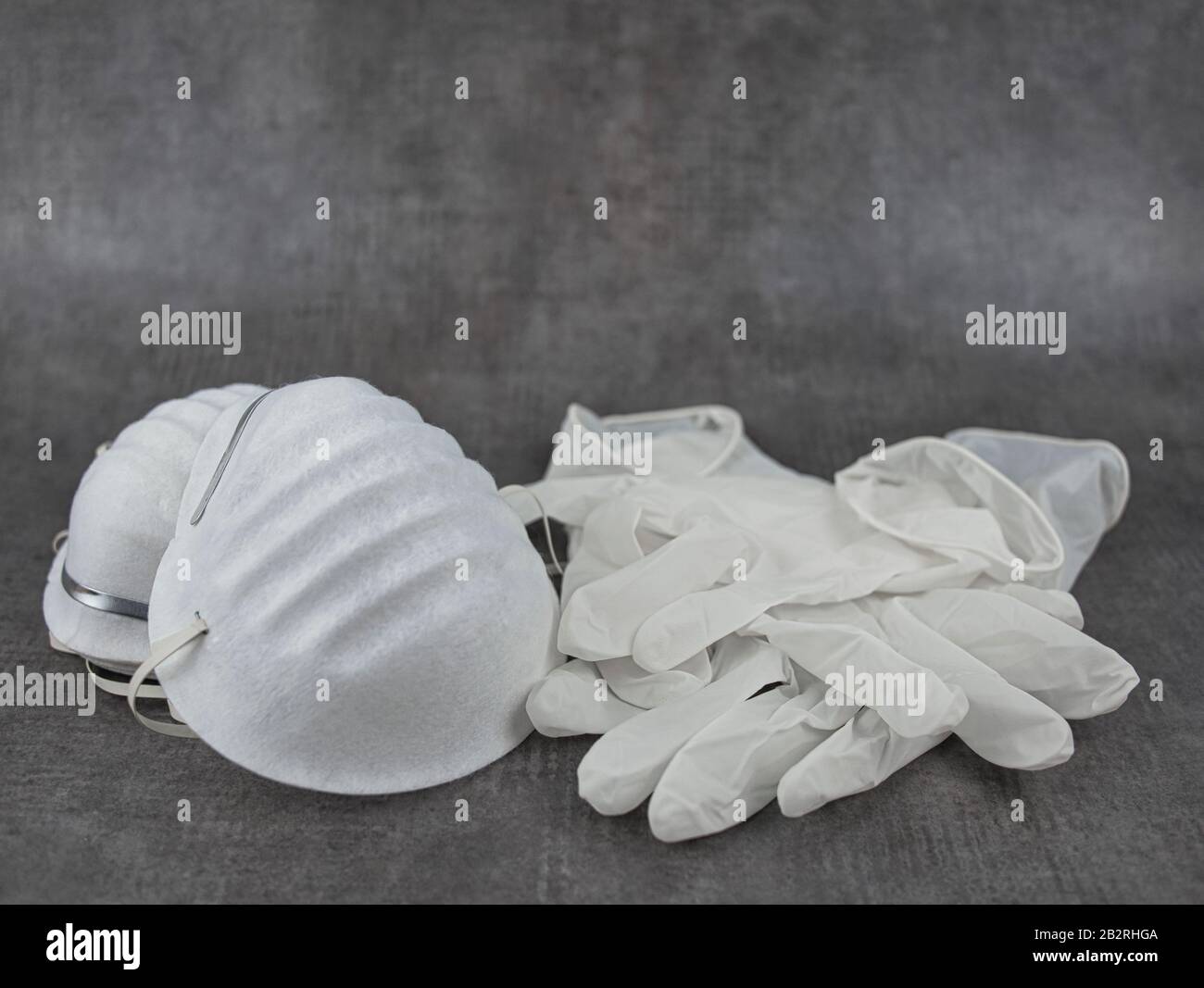 Breathing masks with elastic band and several disposable latex gloves Stock Photo