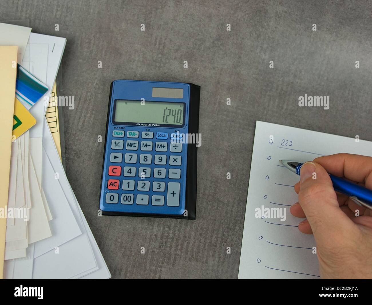 A calculator with documents and a notepad to write Stock Photo