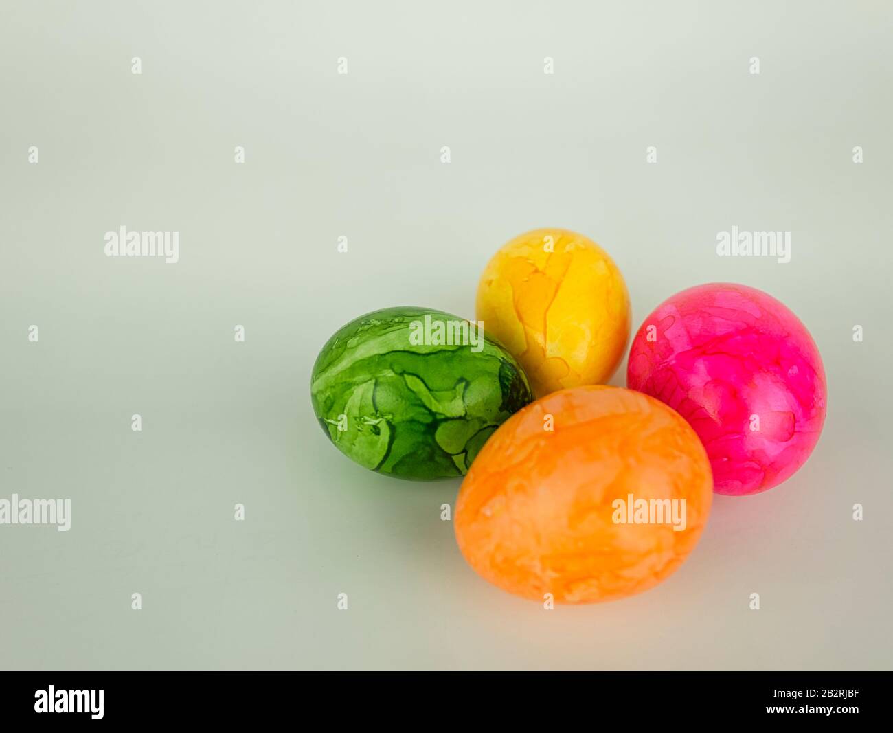 Four colourful painted easter eggs on a white background without decoration Stock Photo
