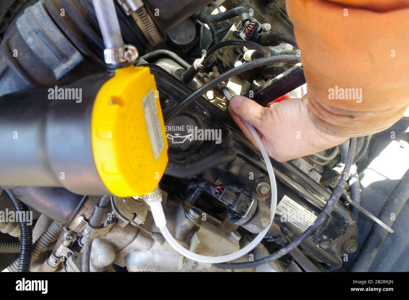 car oil change through the dipstick pump mechanic Stock Photo