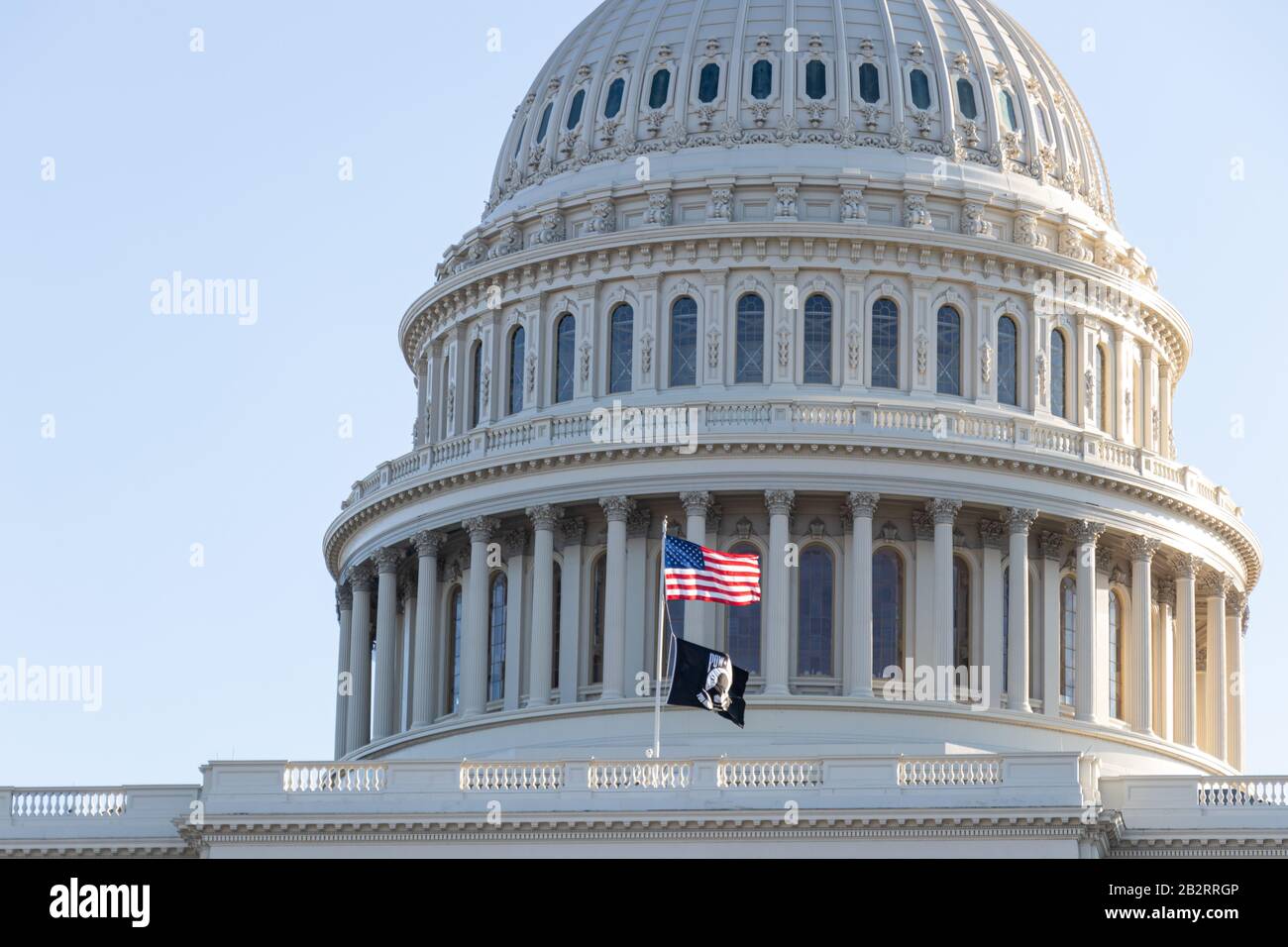 Close up of the United States Capital Dome with the American and POW/MIA flag waving in-front on a clear day. Stock Photo