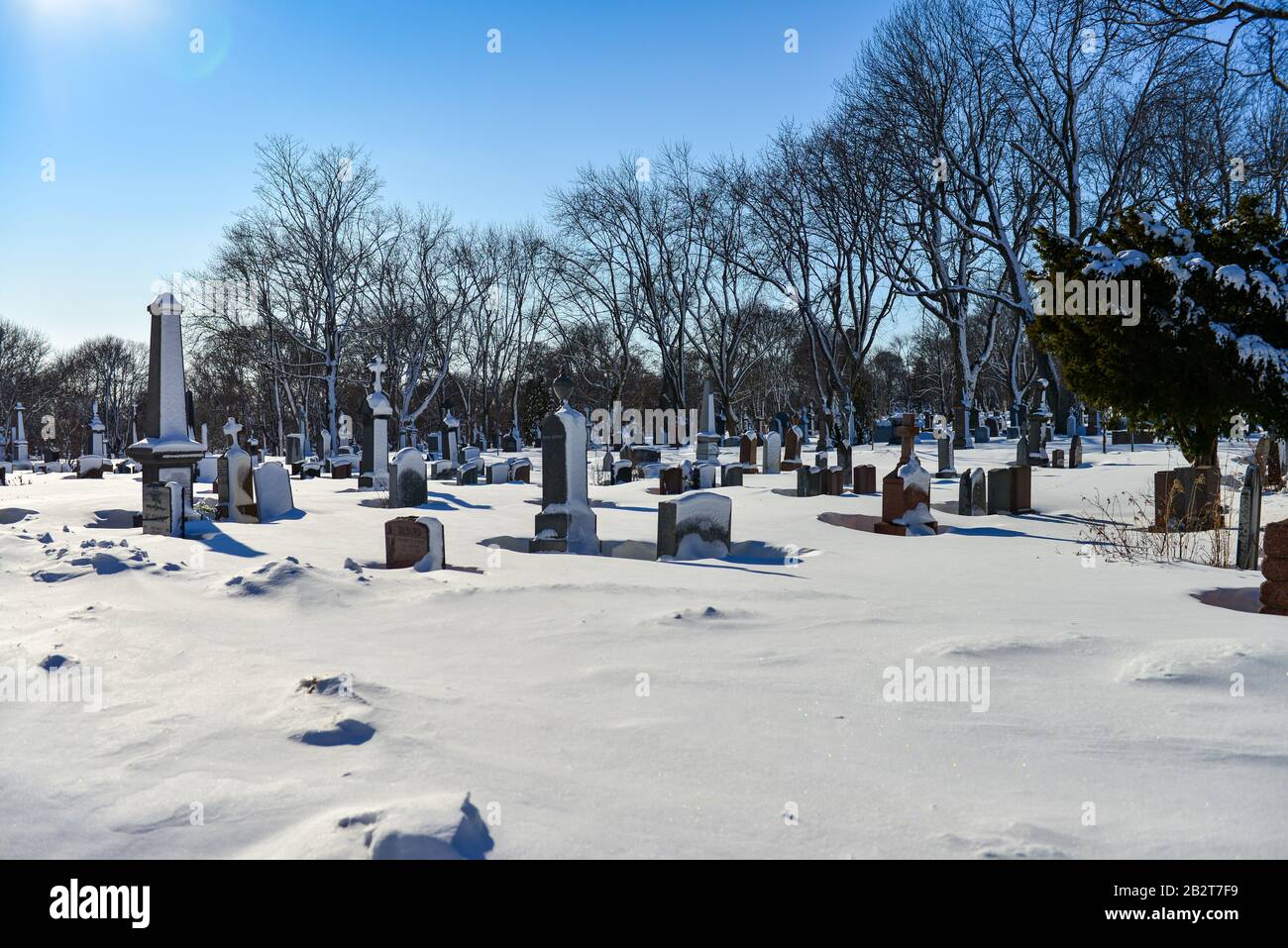 Montreal Quebec Canada march 1 2020: Old Cemetery with snow covered tomb stones on beautiful sunny day, Mount Royal Cemetery Stock Photo