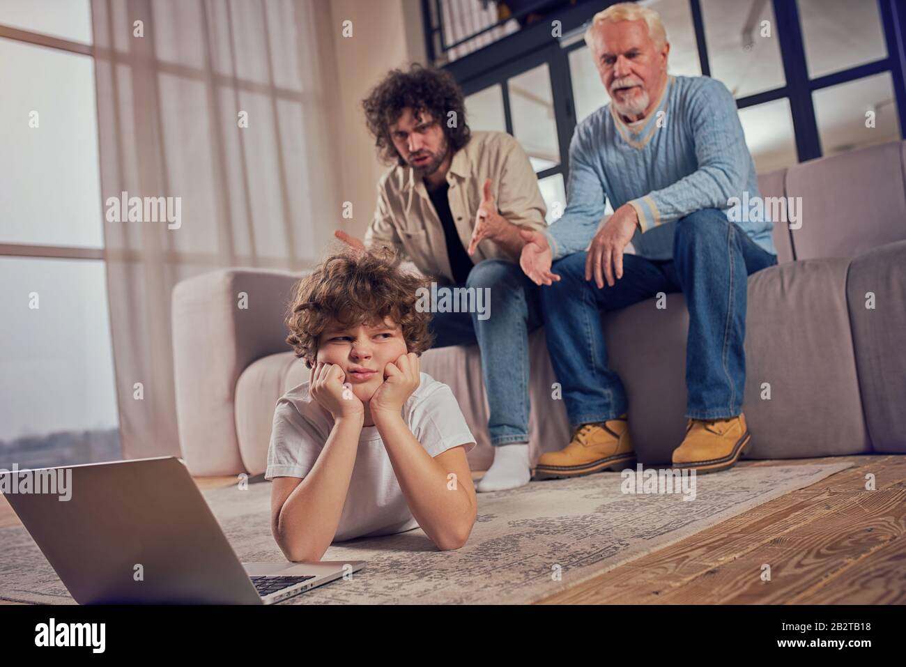 Father get angry and scold his son because he is internet addicted Stock Photo