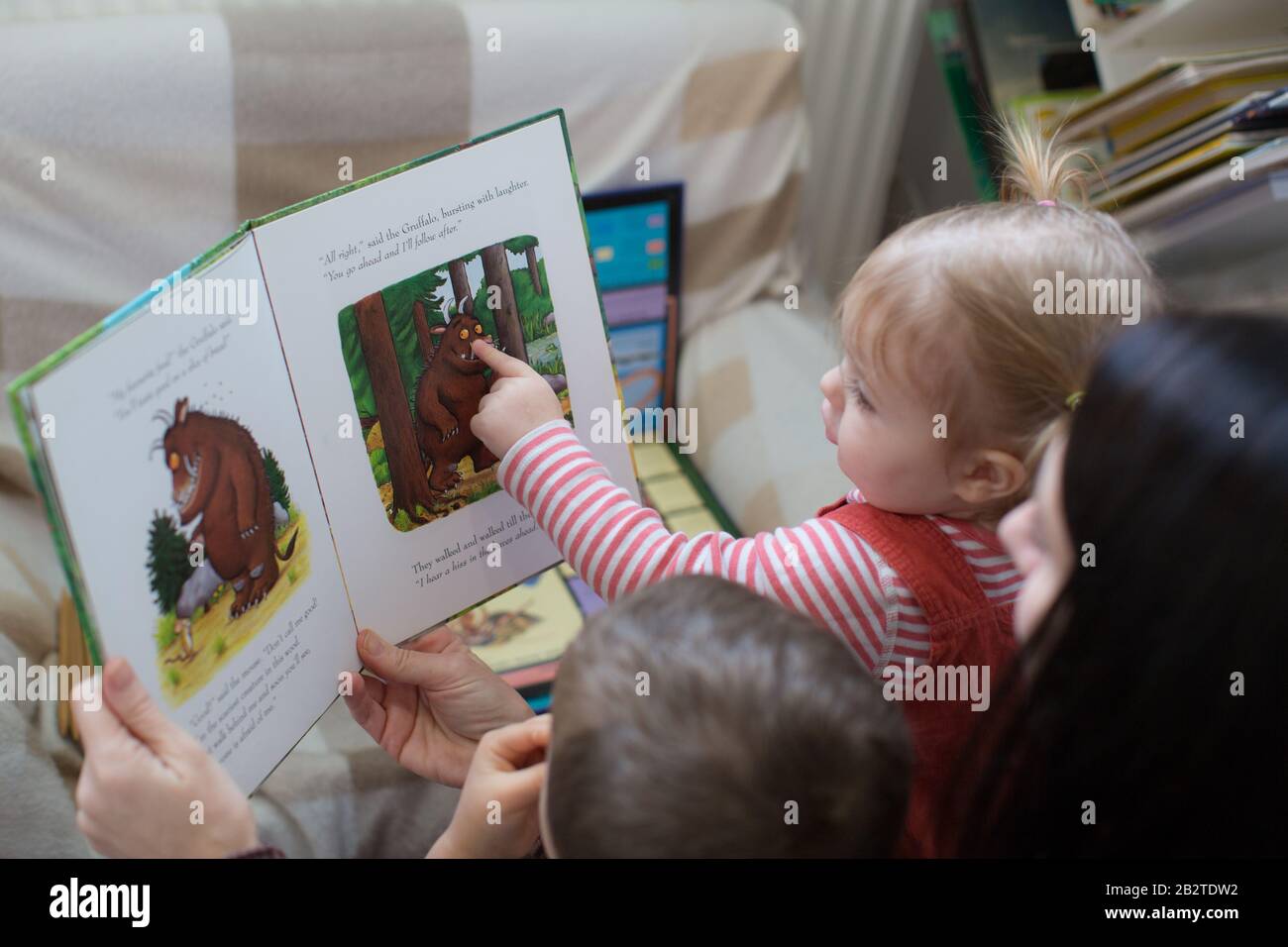 Teacher reading with toddlers, Montessori School, UK Stock Photo Alamy