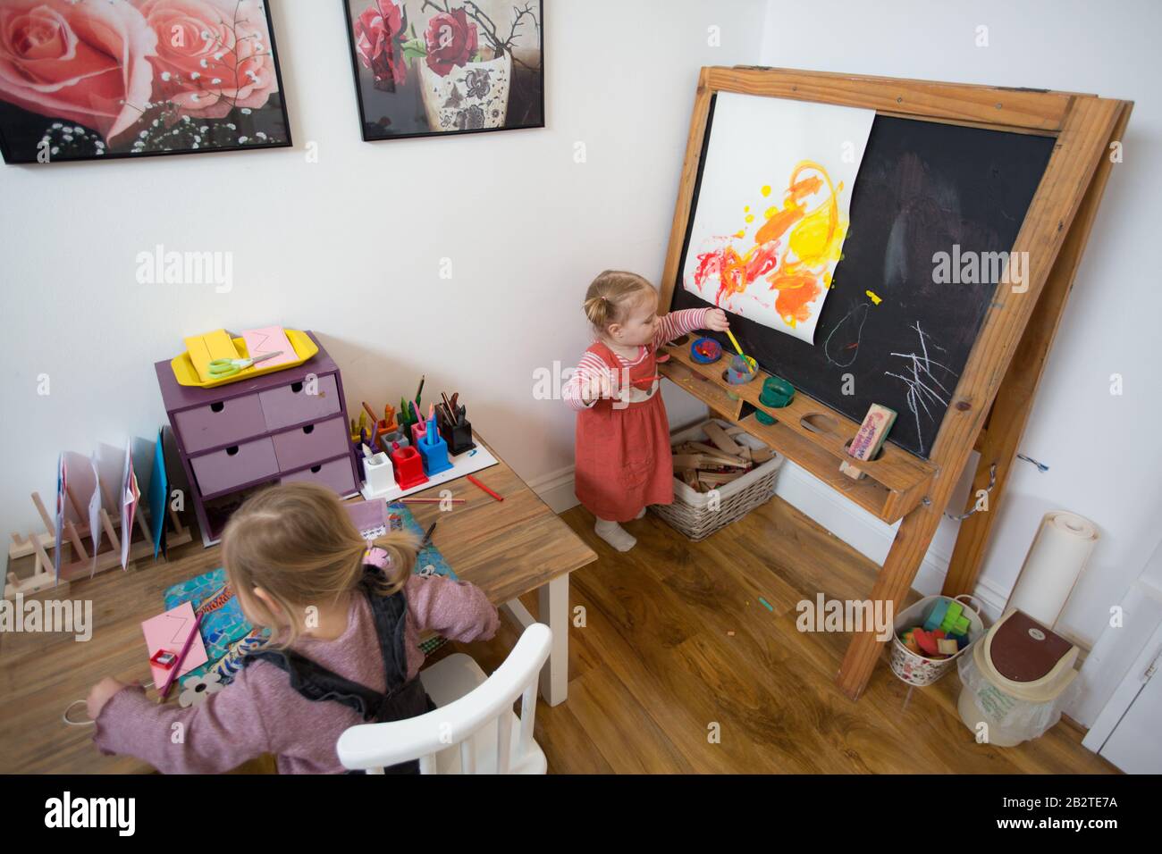 Toddler painting in Nursery, UK Stock Photo