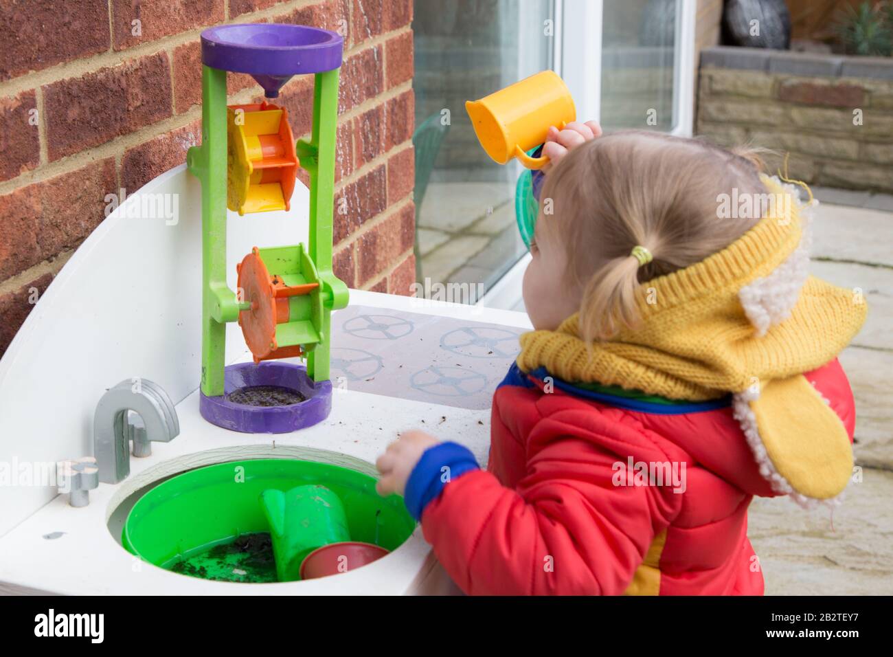 Toddlers playing outside in Montessori Nursery, UK Stock Photo