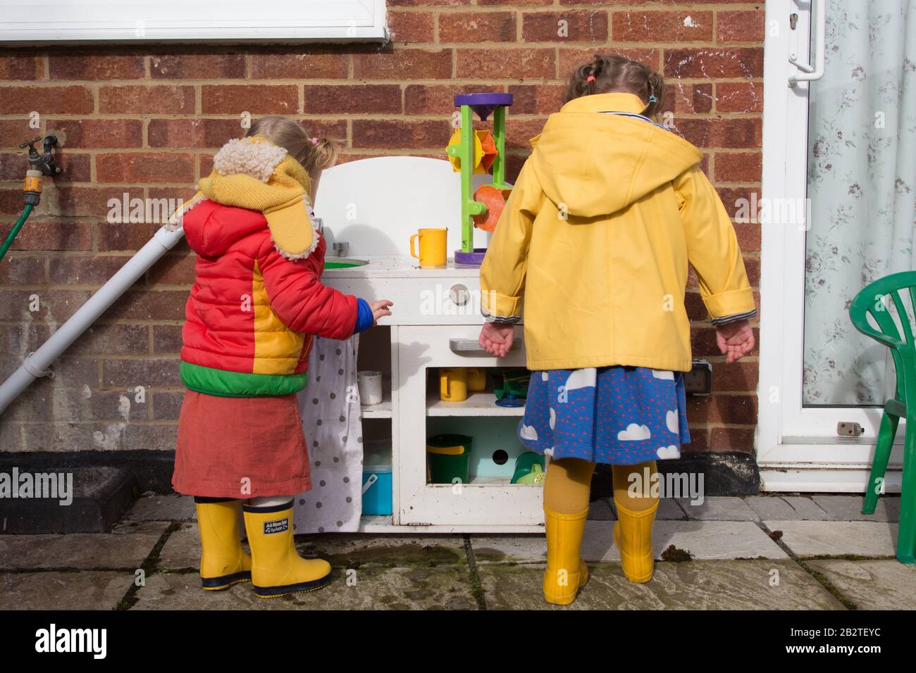 Toddlers playing outside in Montessori Nursery, UK Stock Photo