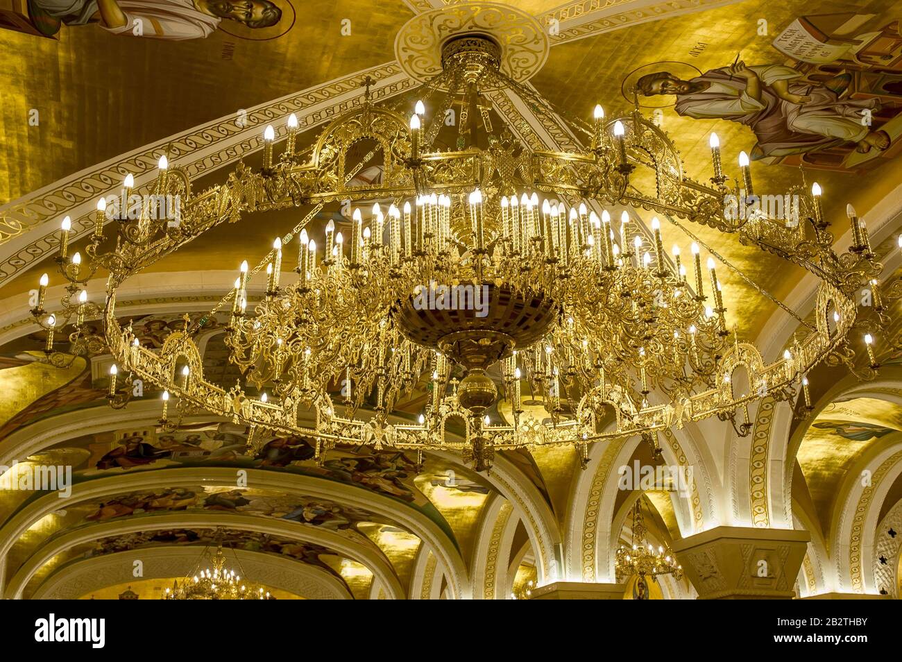 Belgrade, Serbia - February 27, 2020: a golden chandelier with frescoes and arches in the crypt of the Orthodox church Saint Sava in Belgrade, Serbia Stock Photo