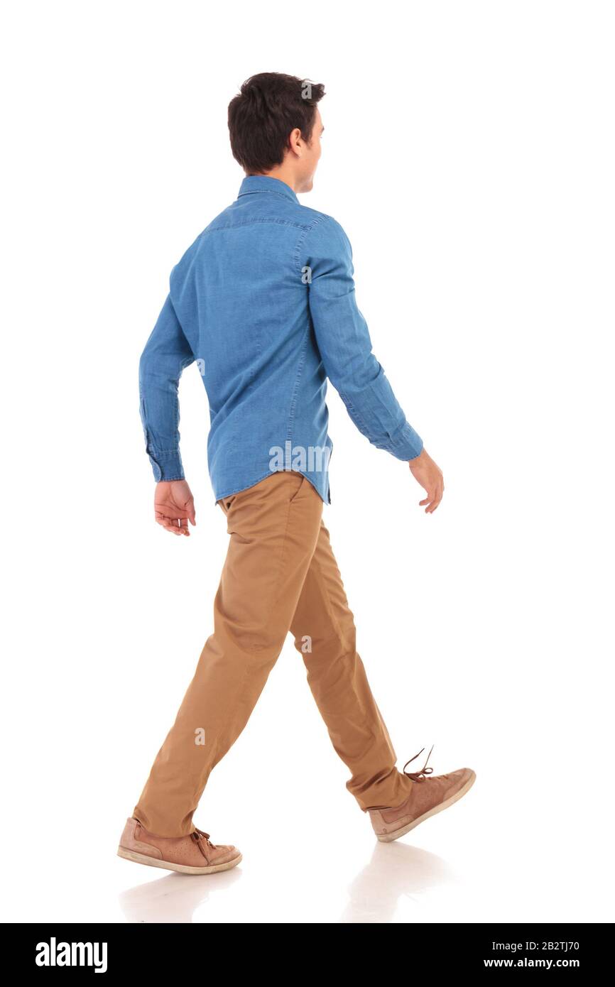 back side view of a walking young casual man on white background Stock ...