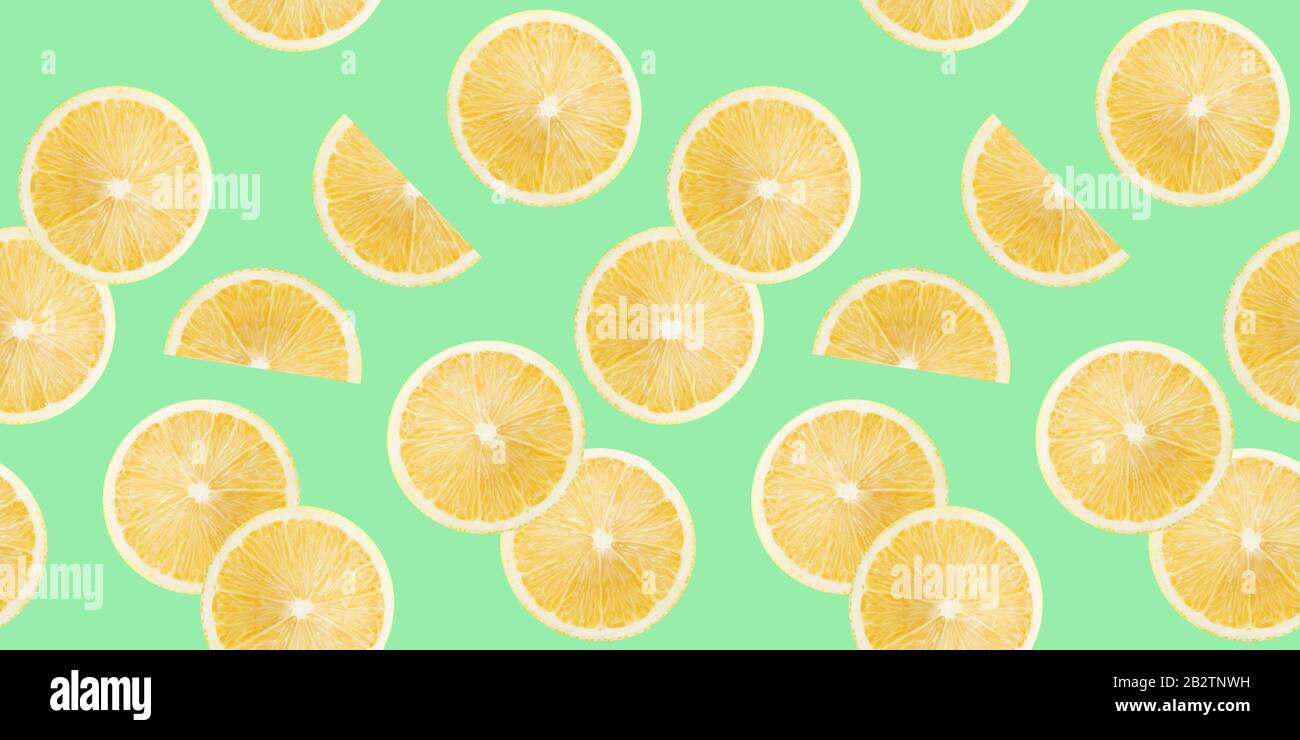 pattern with lemon slices on a light green background. Stock Photo