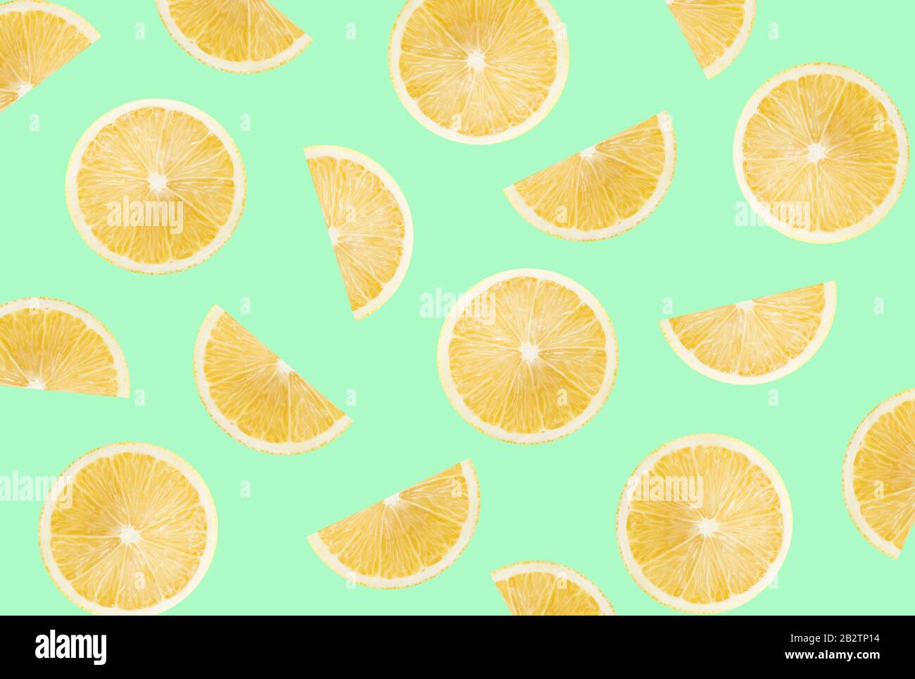 pattern with lemon slices on a light green background. Stock Photo