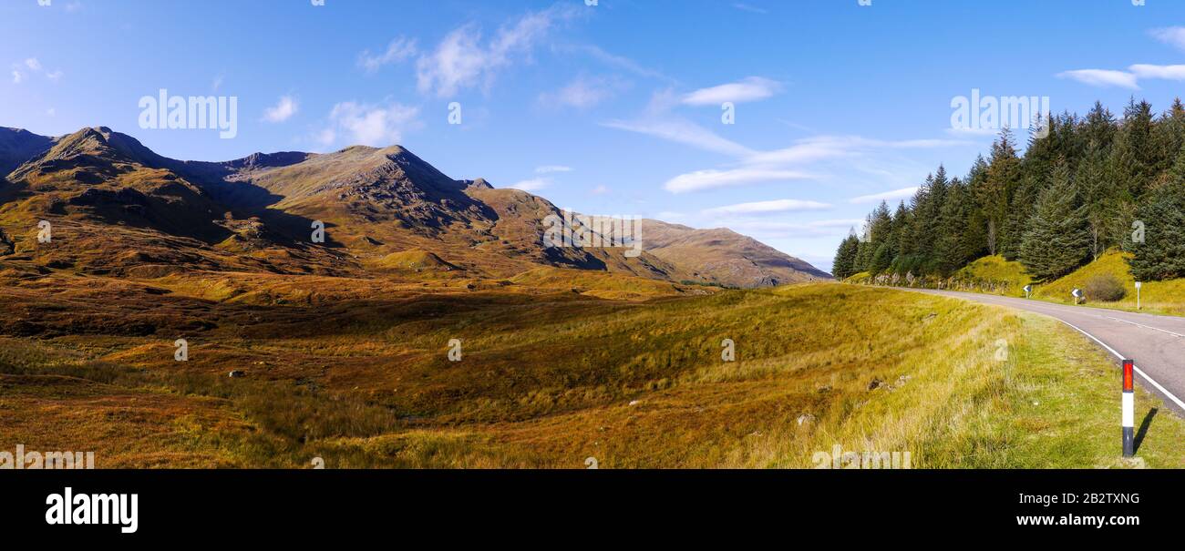 Panoramic view of a mountain range near highway in the midst of the highlands in Scotland Stock Photo