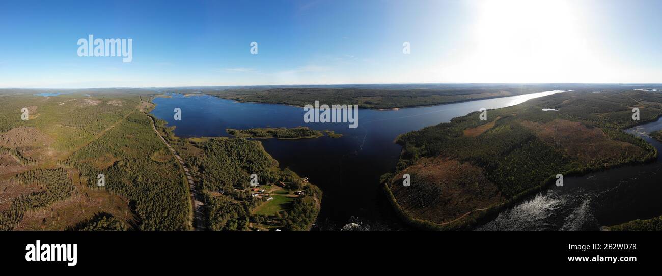 View of Kalix river, Kalixalven, Overkalix locality and the seat in Norrbotten county, Sweden, with forest in sunny summer day, aerial drone view Stock Photo