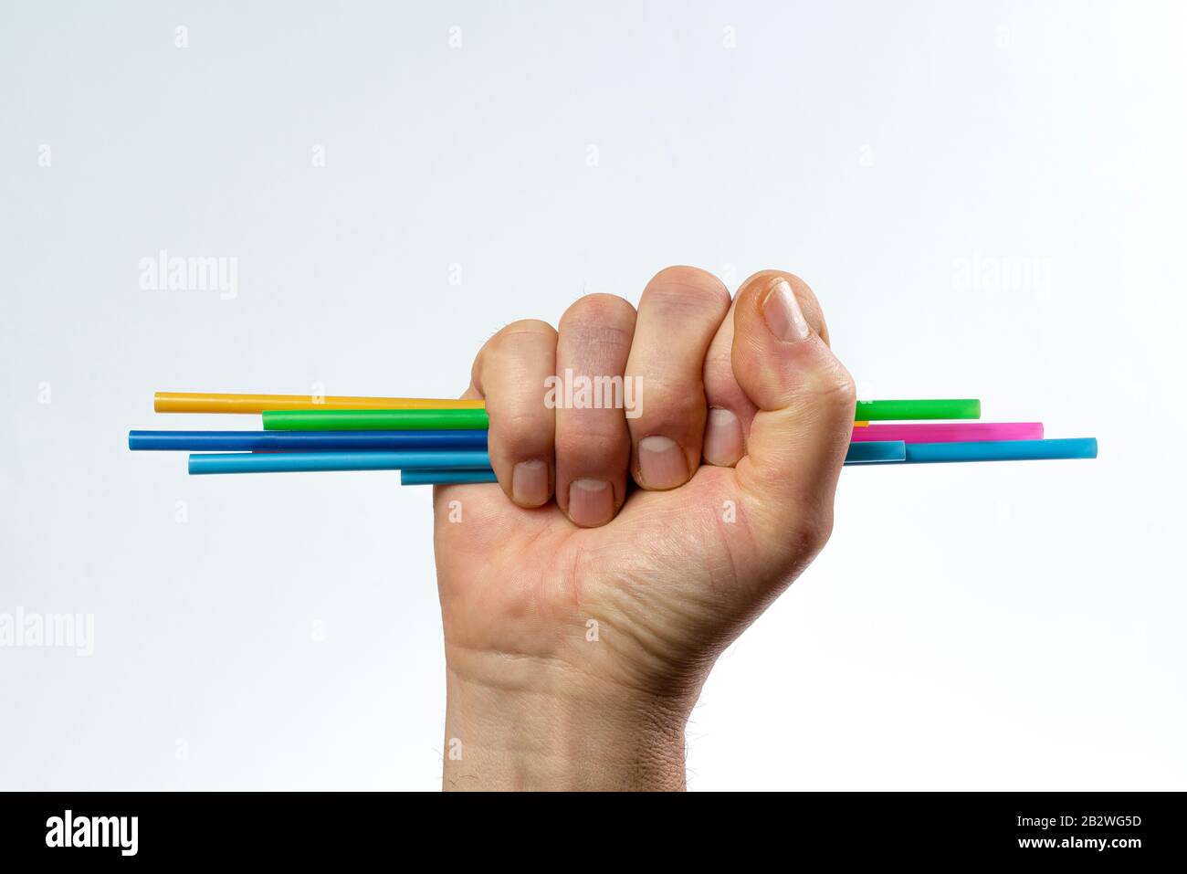 some colored plastic straws in hand Stock Photo Alamy