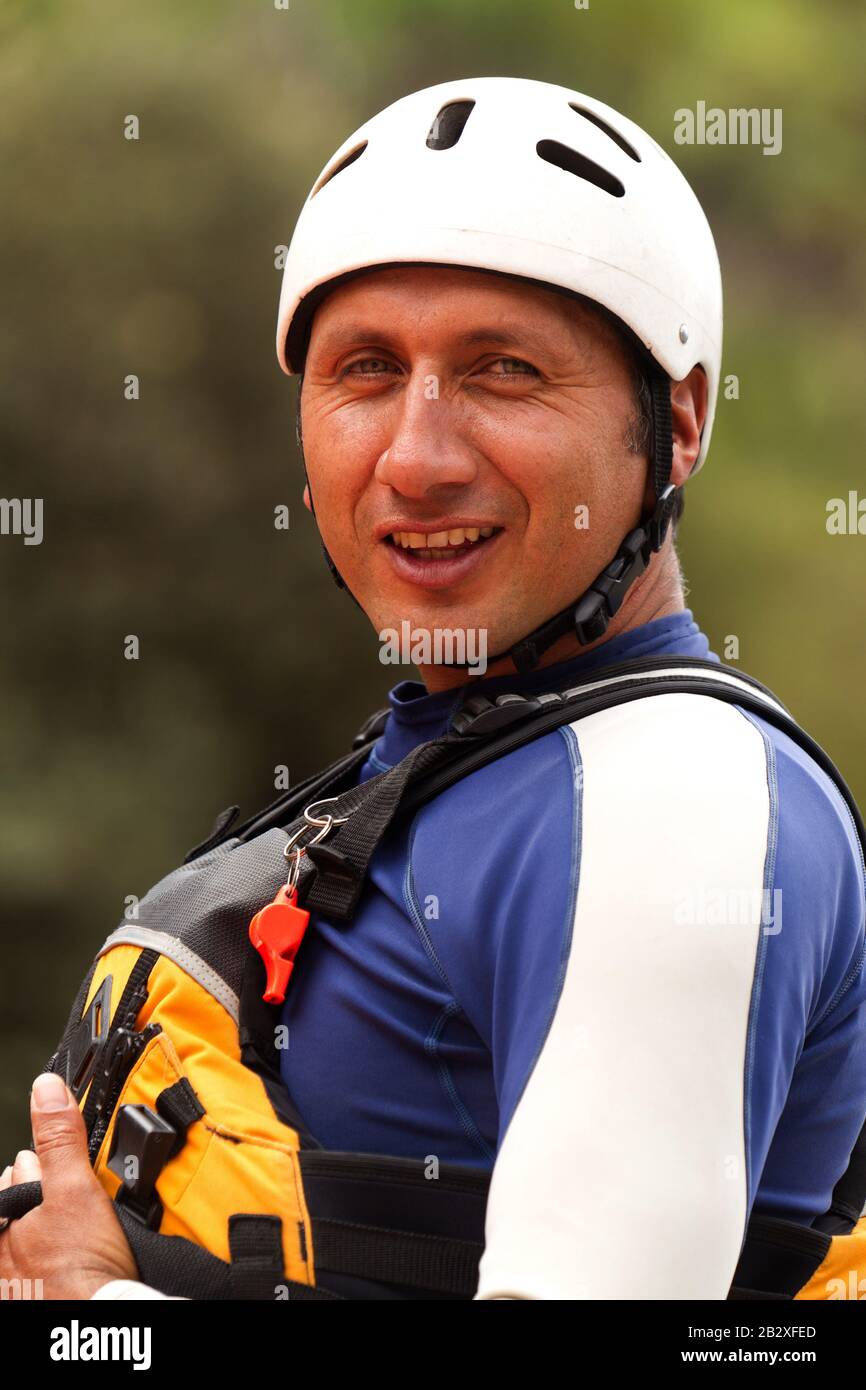 Portrait Of A Confident Rafting Instructor Wearing Typical Outfit For Watersports Stock Photo