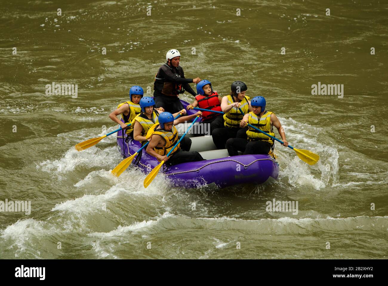 Crowd Of Mixed Pilgrim Male And Women With Guided By Specialist Pilot On Whitewater Flow Rafting In Ecuador Stock Photo