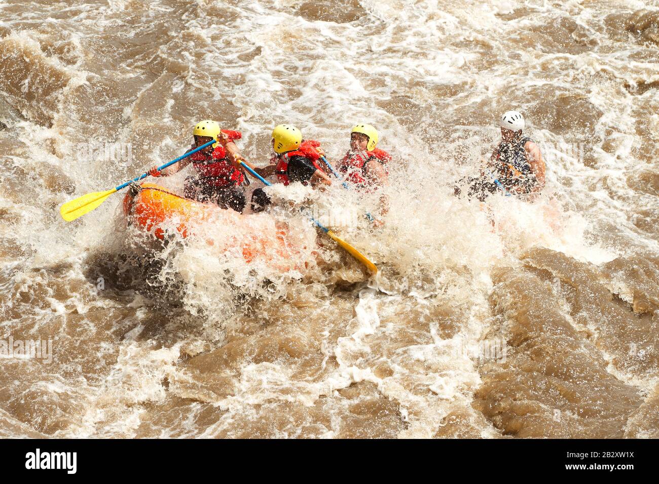 Crowd Of Mixed Mountaineer Men And Lady With Guided By Professional Pilot On Whitewater Flow Rafting In Ecuador Stock Photo