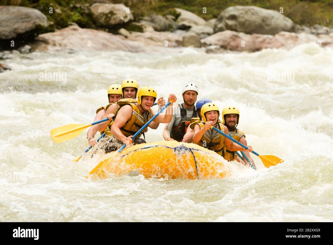 Community Of Mixed Pioneer Human And Lady With Guided By Professional Pilot On Whitewater Creek Rafting In Ecuador Stock Photo