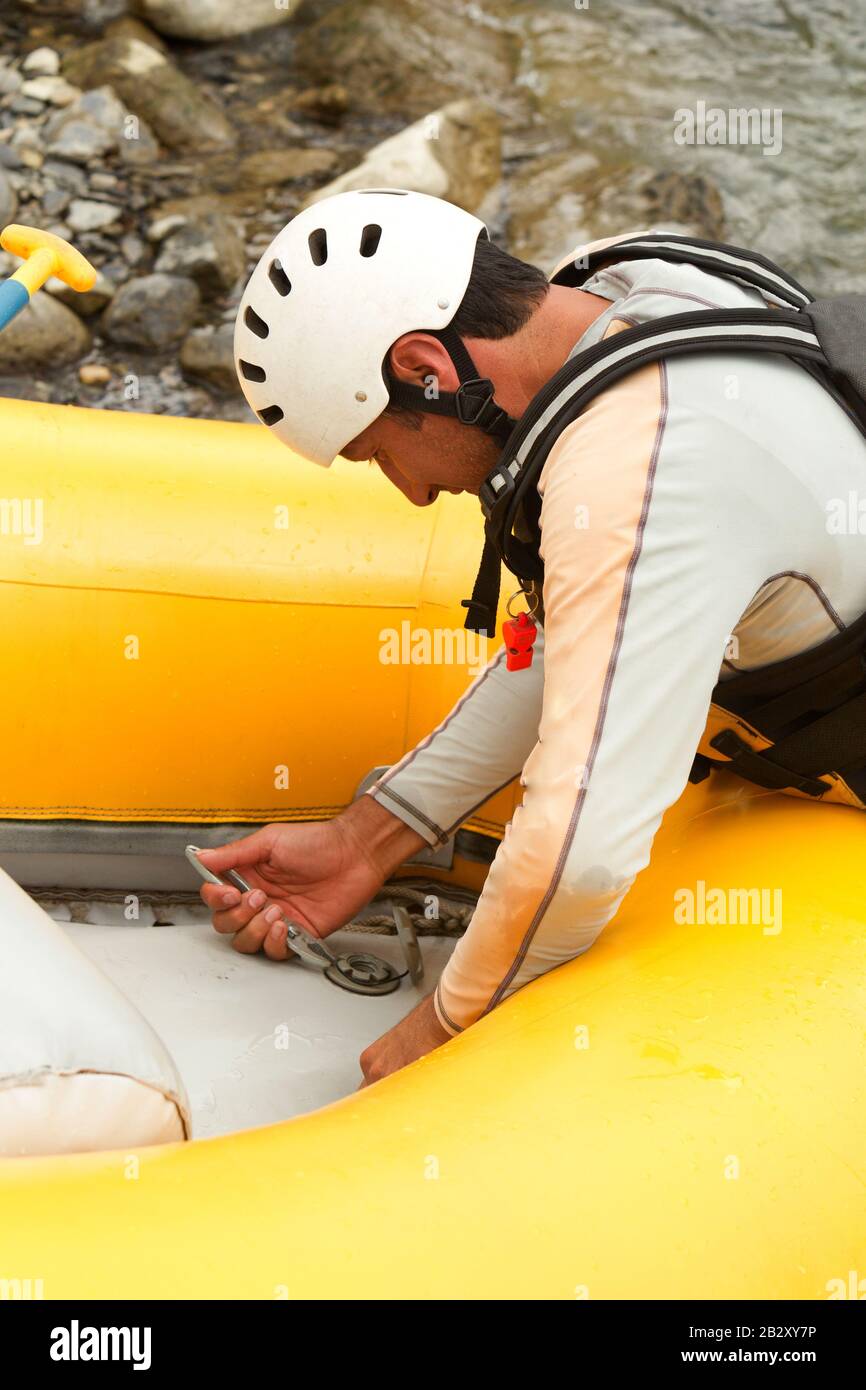 Rafting Boat Maintenance The Pilot Preparing The Boat For The Next Adventure Stock Photo