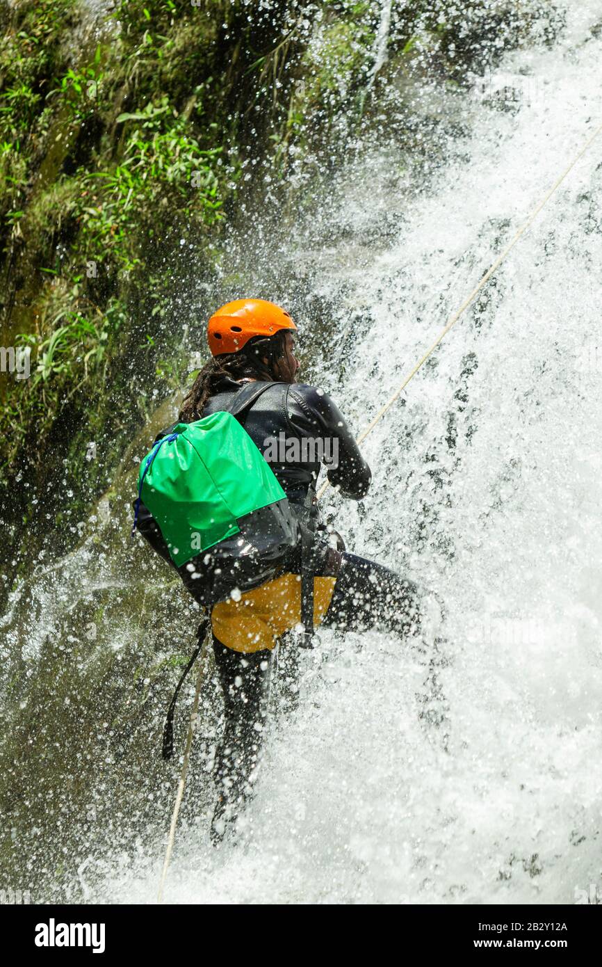 Canyoning Leader Trying Out A New Path In Chama Waterfall Banos De Agua Santa Ecuador Stock Photo