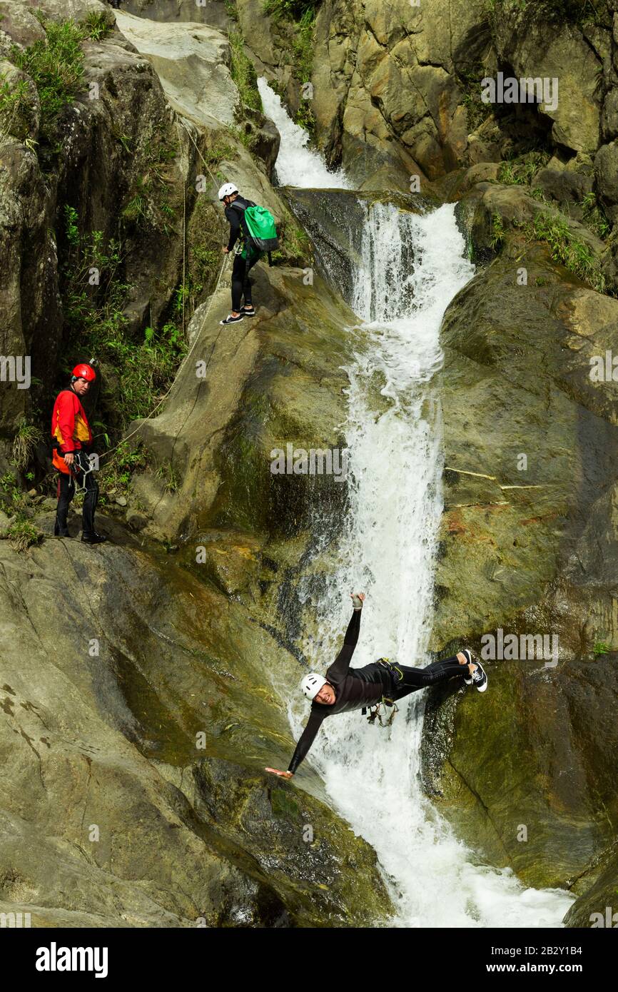 Canyoning Leader Trying Out A New Direction In Chama Waterfall Banos Ecuador Stock Photo