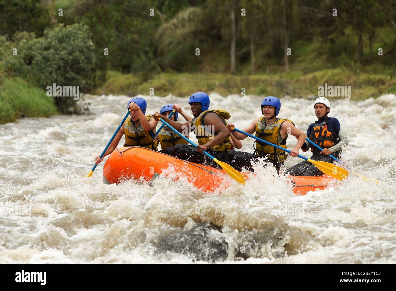 Union Of Mixed Pioneer Male And Lady With Guided By Professional Pilot On Whitewater Waterway Rafting In Ecuador Stock Photo