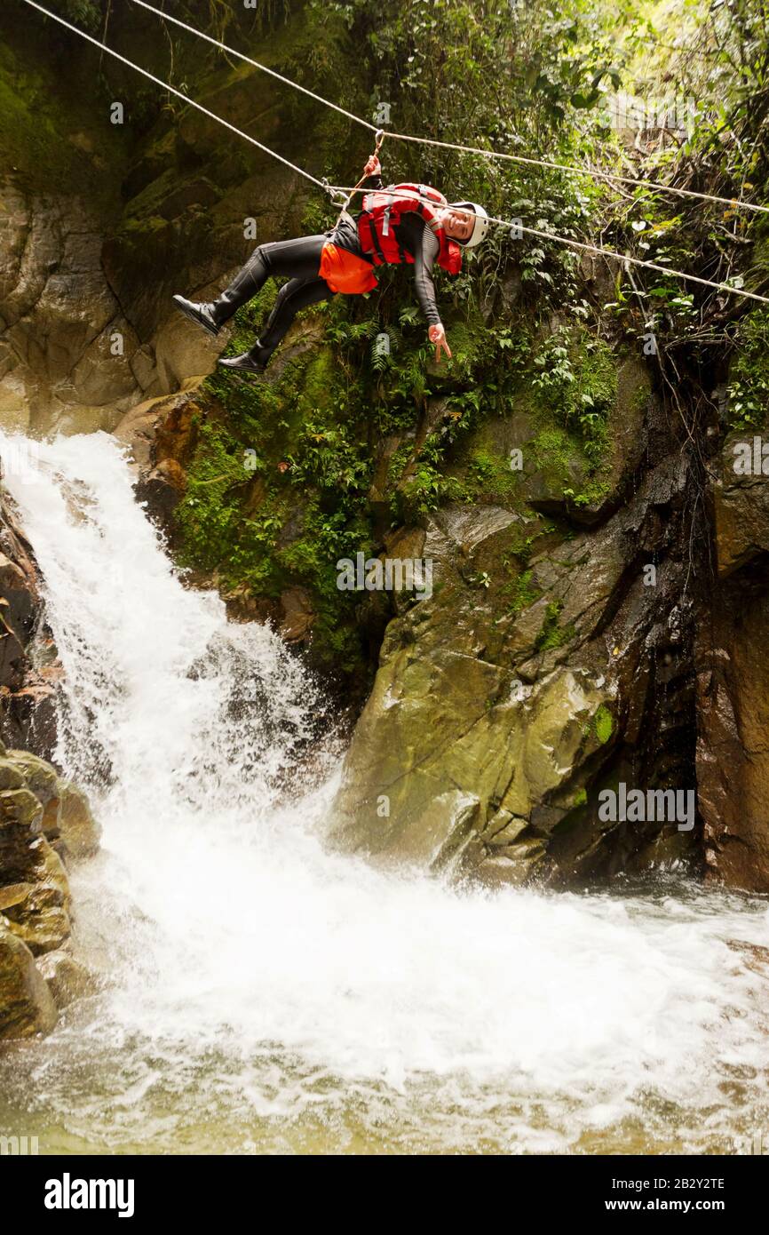 Young Fat Woman Hanging Over A Waterfall Stock Photo