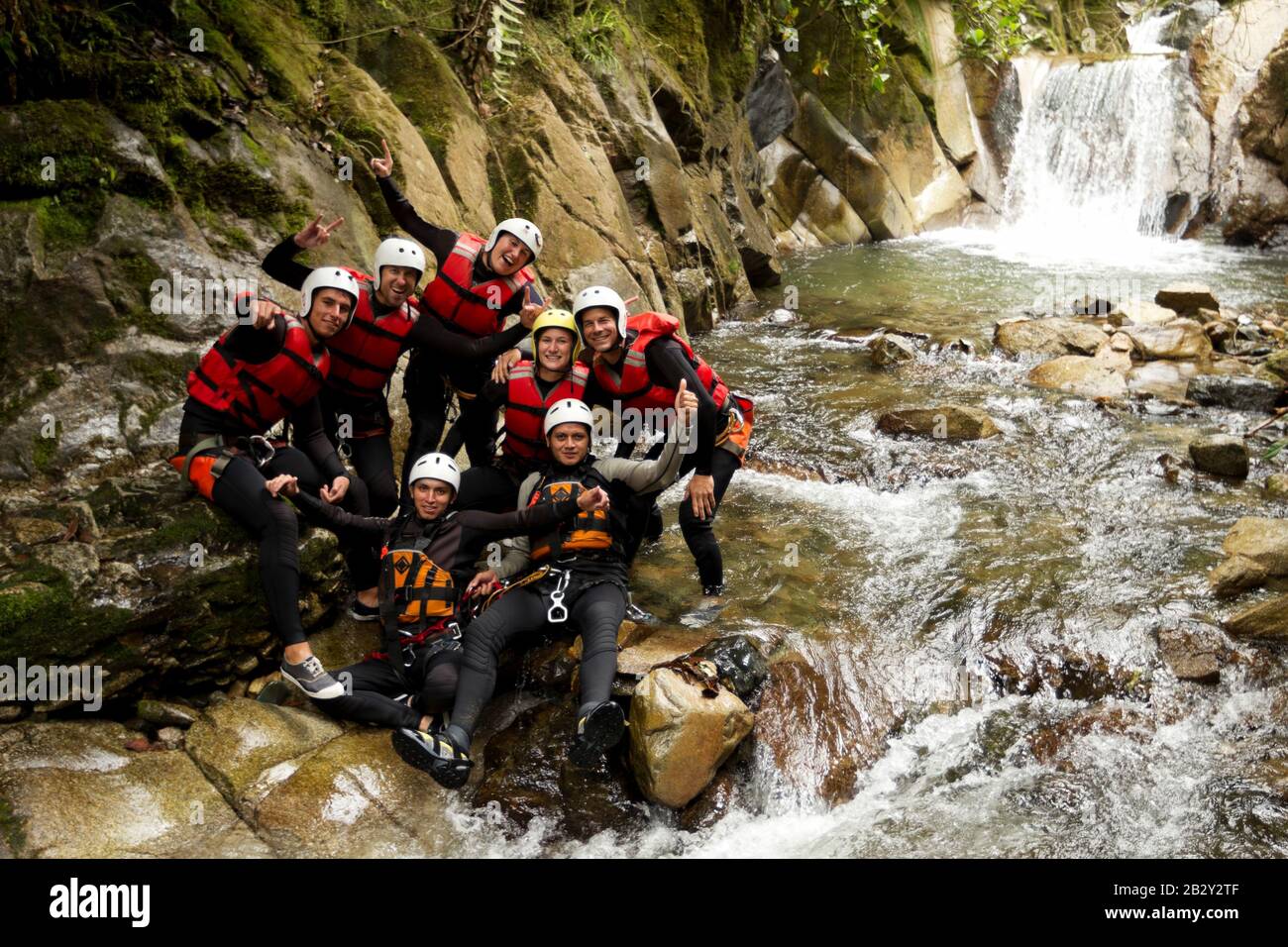 Union Of Active Teenage Human During A Canyoning Expedition In Ecuadorian Rainforest Stock Photo