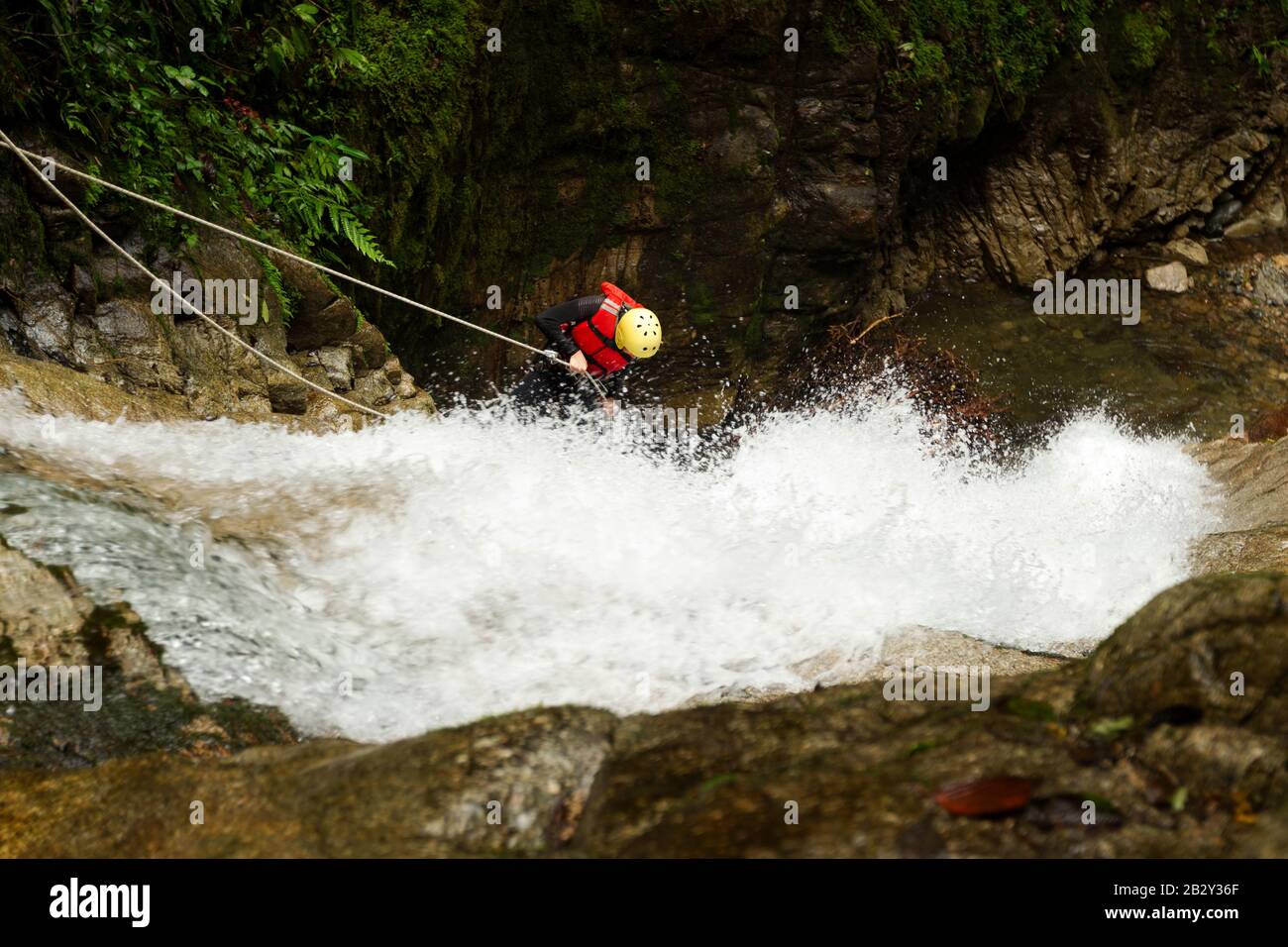 Grown Woman Wear Seal Equipment Descending A Waterfall Stock Photo