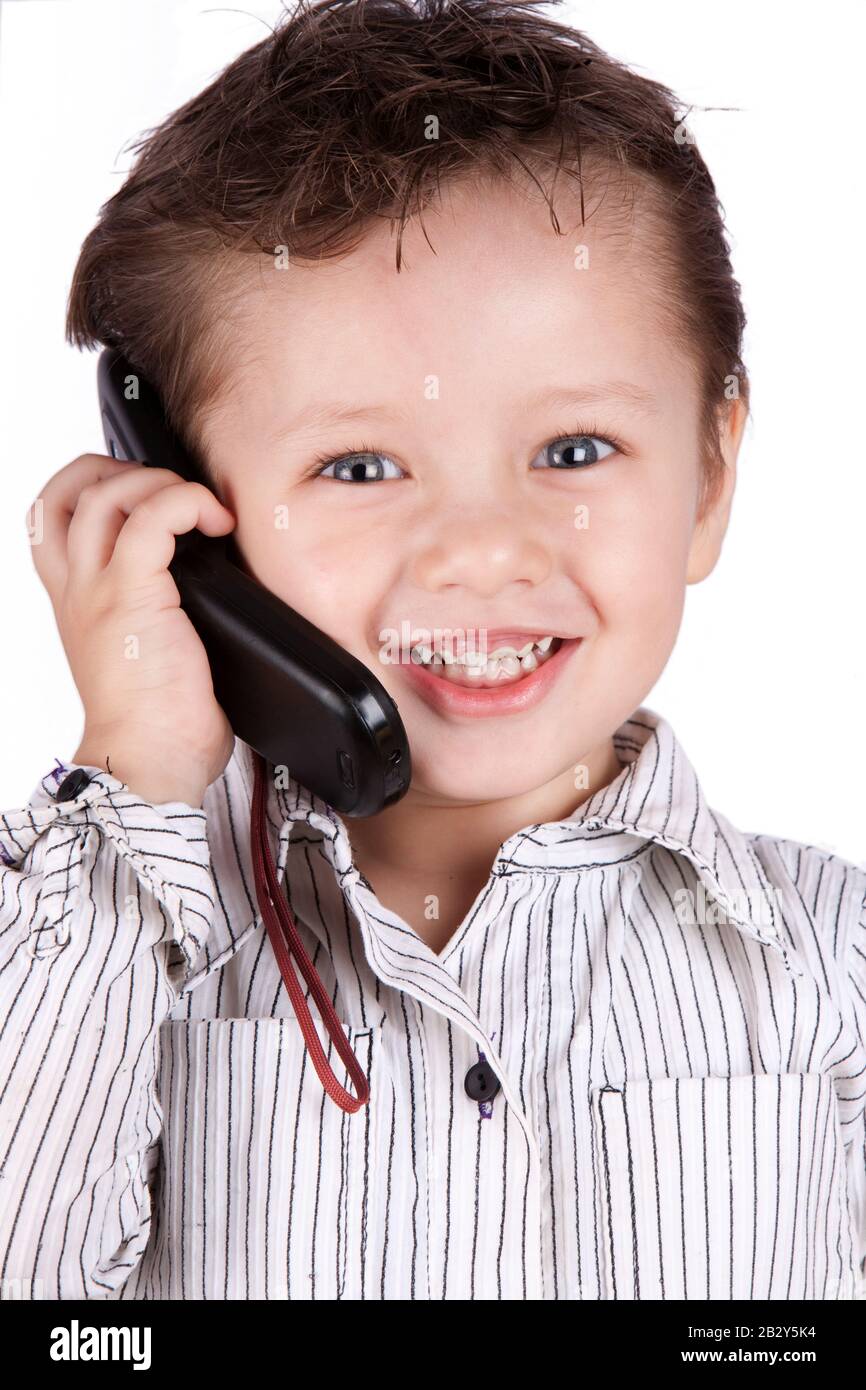 Young Children Posing As Businessman Speaking On His Mobile Phone Stock Photo
