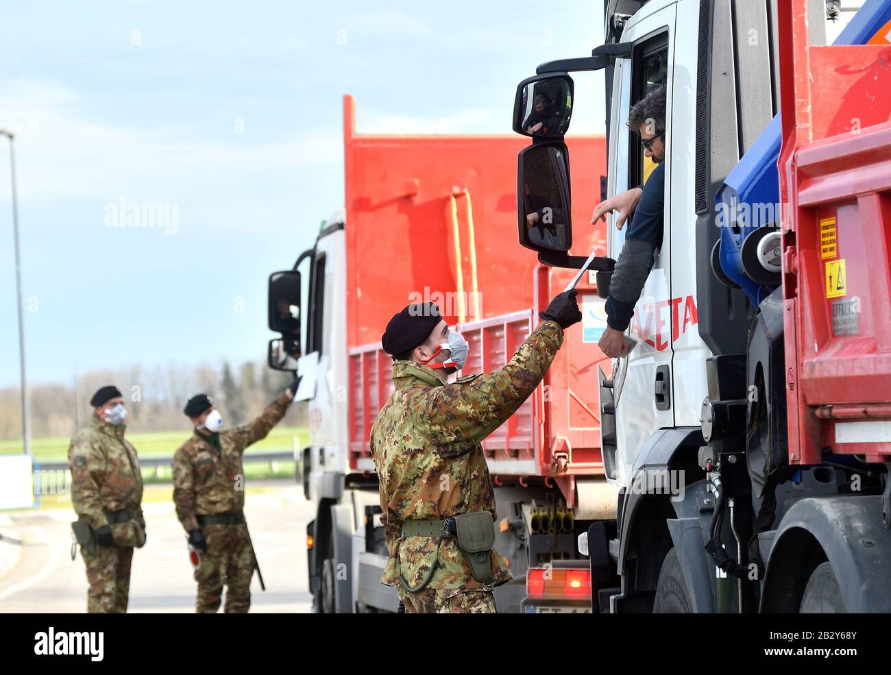 Turano Lodigiano. 4th Mar, 2020. Italian Army soldiers check transit to and from the cordoned areas in Turano Lodigiano, Italy, Feb. 27, 2020. Italian authorities on Tuesday confirmed 2,263 coronavirus cases, which marked an increase of 428 infections compared to the previous day. The figure did not include recoveries or fatalities, whose numbers were provided separately. Credit: Xinhua/Alamy Live News Stock Photo