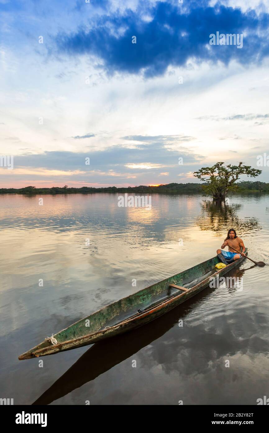 Aboriginal Mature Man With Kayak On Laguna Grande Cuyabeno National Park Ecuador At Sundown Model Released Stock Photo