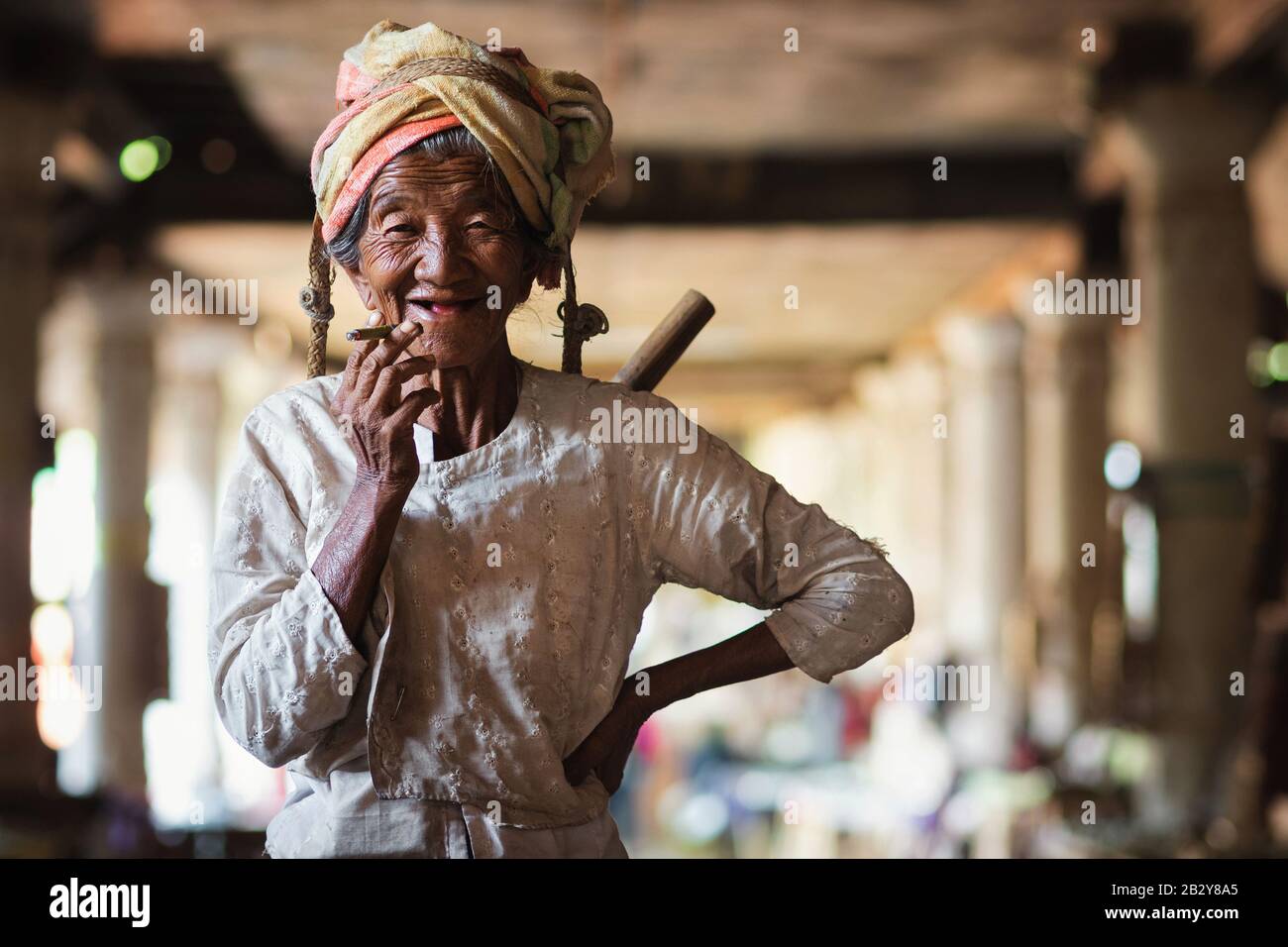 Shan State, Myanmar (Burma), happy old lady of Pa O ethnic minority smiling and smoking a Burmese cigar at Indein village near Inle Lake. Stock Photo