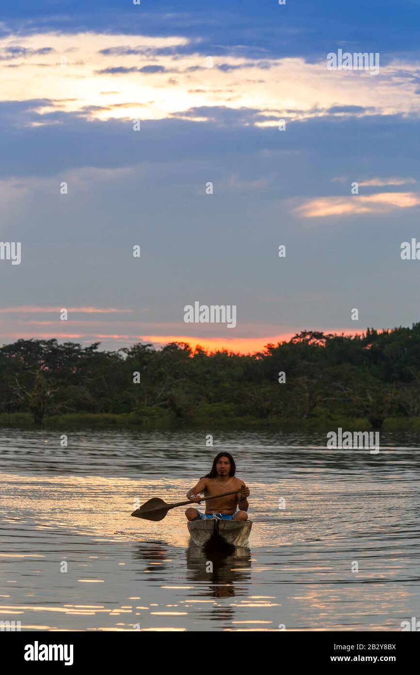 Indigens Mature Man With Kayak On Laguna Grande Cuyabeno National Park Ecuador At Sundown Model Released Stock Photo