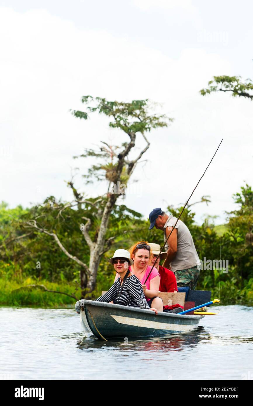 Pilgrim Boat Cruising On Murky Amazonian Aqua In Cuyabeno Wild Animal Reserve Stock Photo