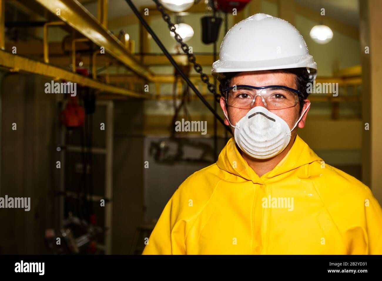 Slaughterhouse Butcher Wearing Specific Protection Equipment Against Production Line Background Stock Photo