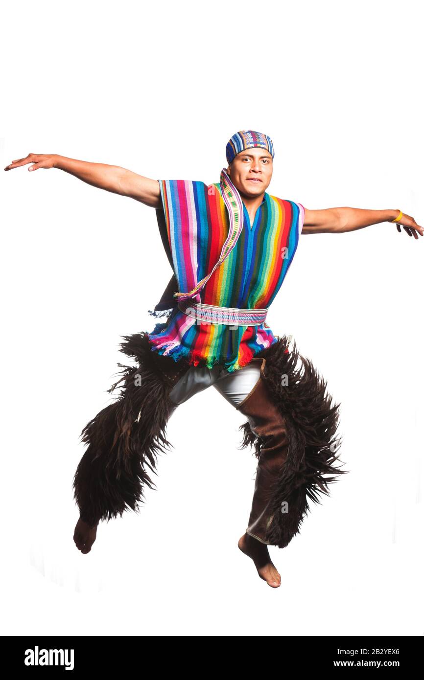 Ecuadorian Dancer Dressed Up In Traditional Clothing From The Andean Performing A Jump Llama Or Antelope Pants Studio Shot Isolated On Colour Stock Photo
