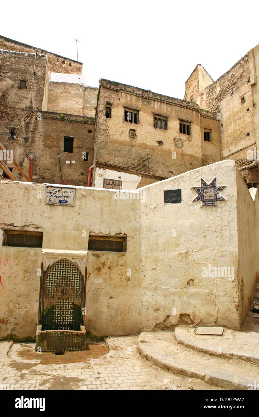 Water fountain, houses and signs on a typical residential street in the