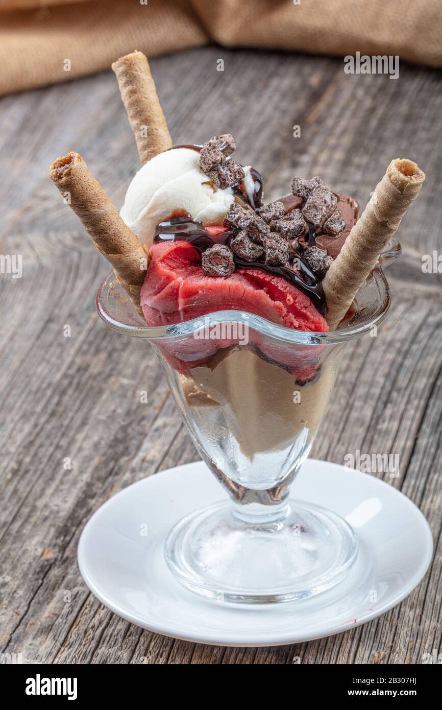 Vanilla, strawberry and chocolate sundae dish ice cream with wafer