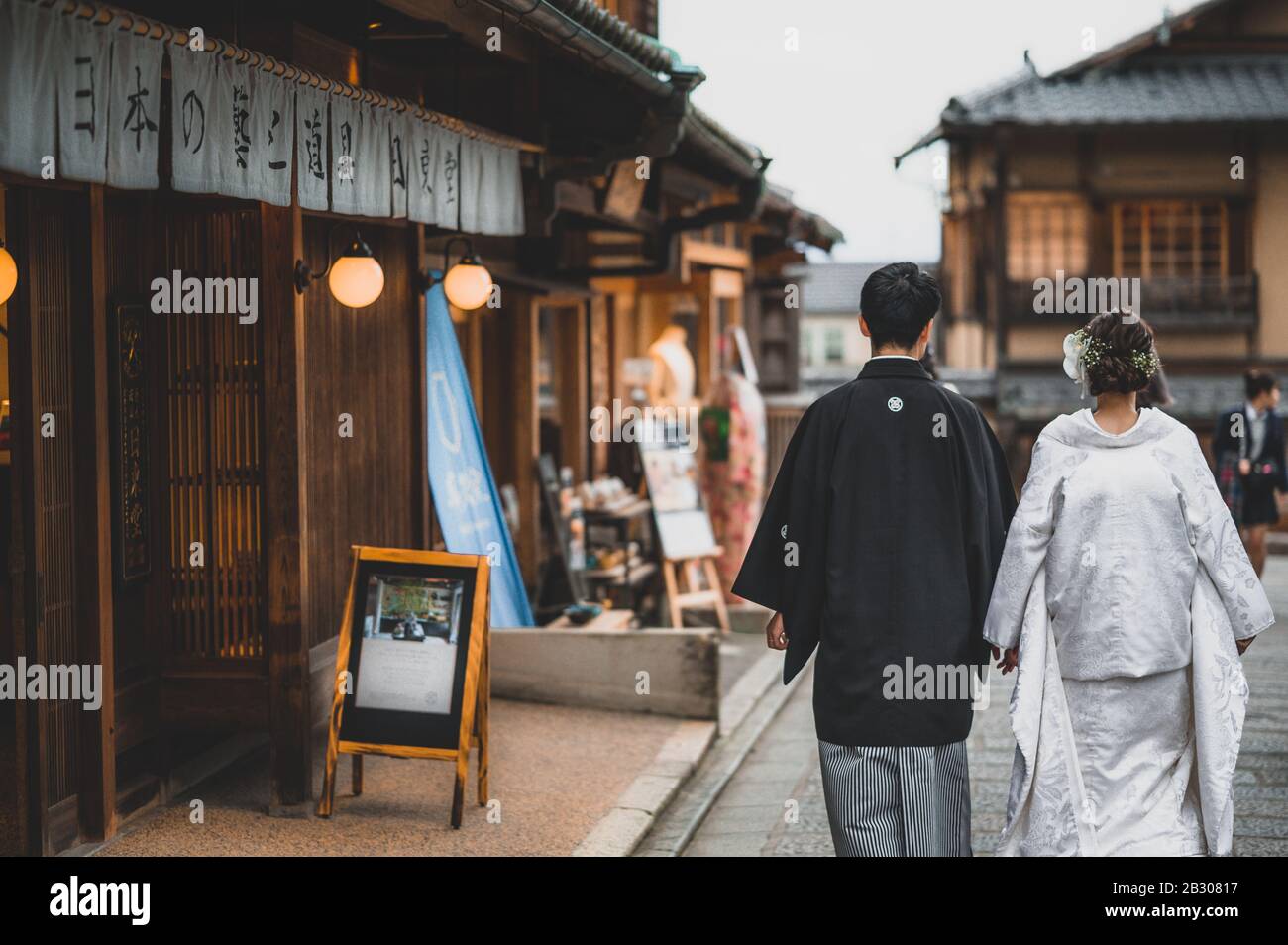 A japanese couple on their wedding day dressed up in traditional kimono taking photo shots in kyoto Stock Photo