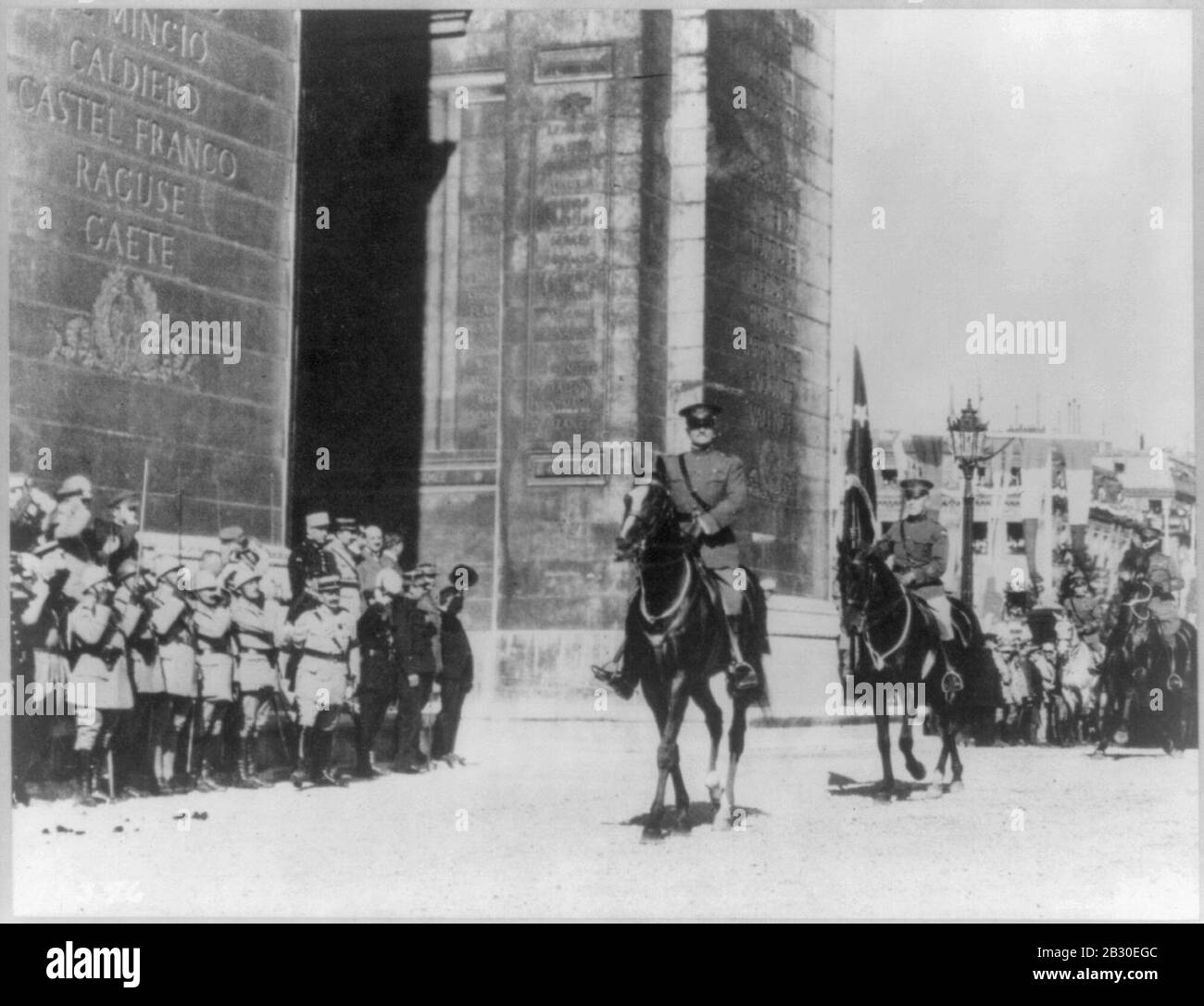 Gen. Pershing riding through Arc de Triomphe in parade with aide-de ...