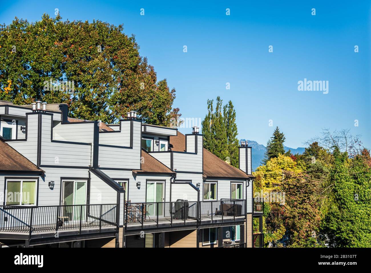 Top of new residential building on blue sky background Stock Photo - Alamy