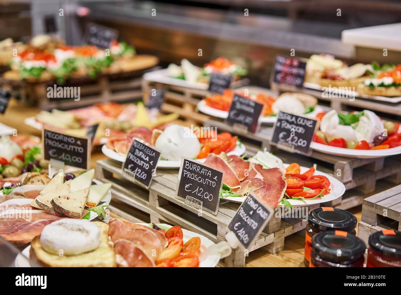 Various snacks and antipasti on the table of showcase. Street food