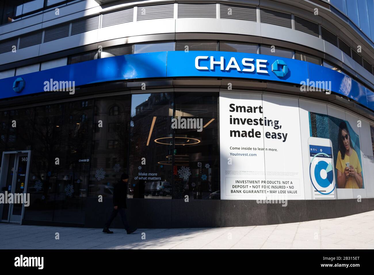 Chase Bank branch on a street corner as man walks by in downtown Washington, D.C. Stock Photo