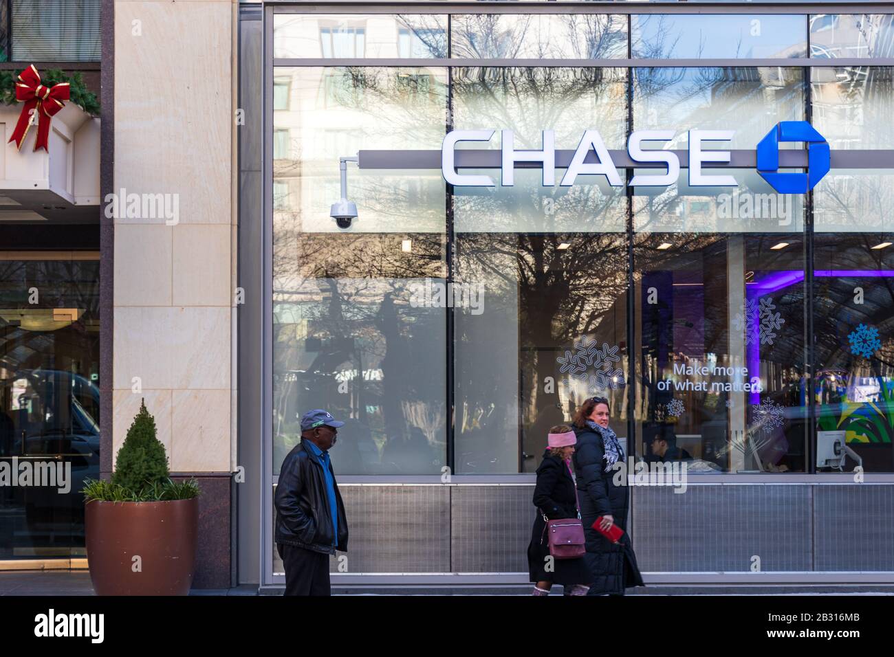 People walk by Chase Bank sign on the front of a bank branch in D.C. Stock Photo